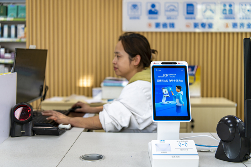 2024年4月10日，浙江金華市區(qū)一家民眾大藥房柜臺上設(shè)置著醫(yī)?！八⒛樦Ц丁睓C(jī)器，群眾看病更加便利。